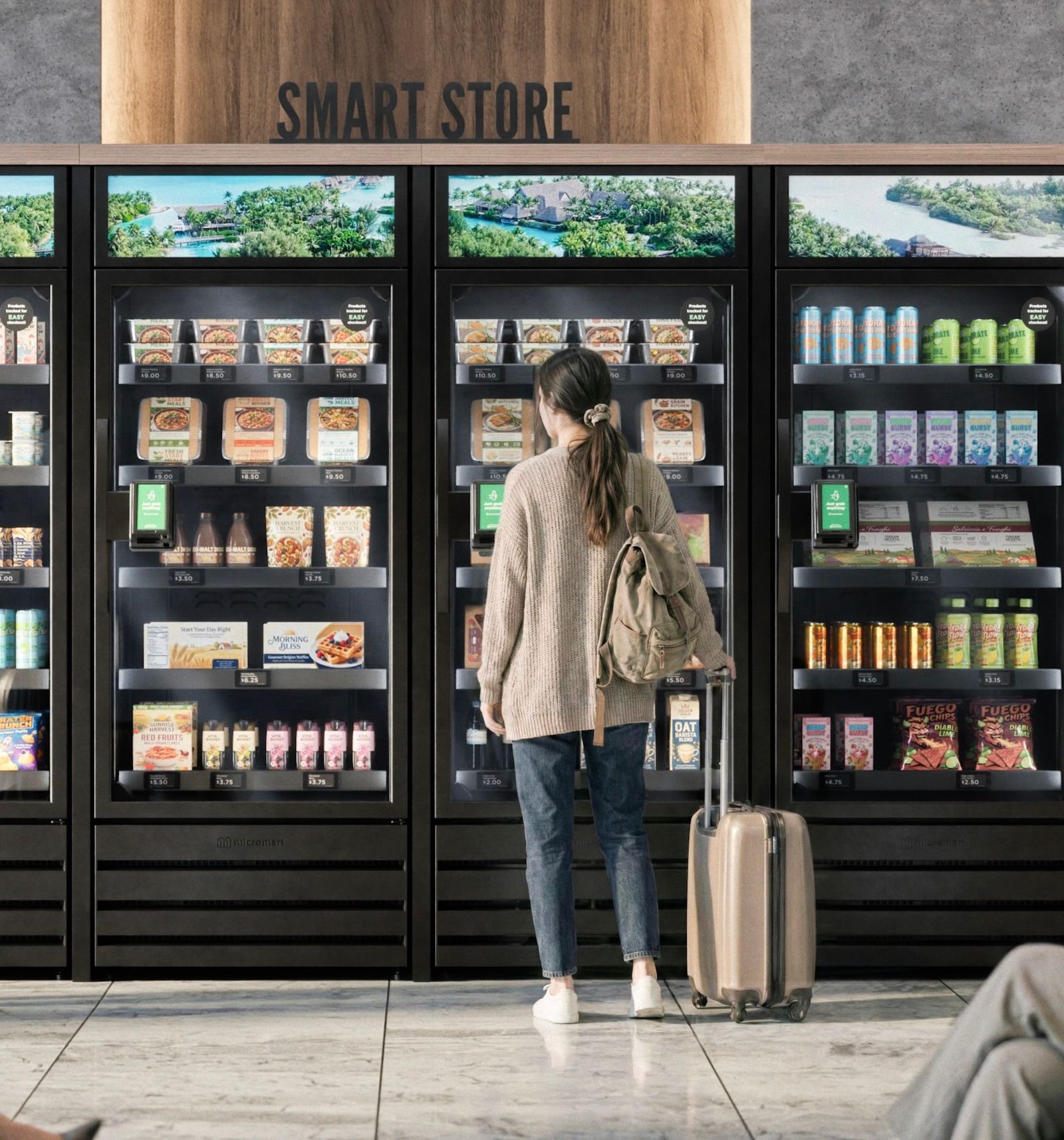 A customer standing in front of a modern smart-store vending wall with fresh food and drinks.